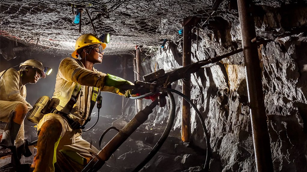 Employees work in an underground PGM mine in South Africa