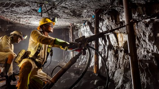 Employees work in an underground PGM mine in South Africa