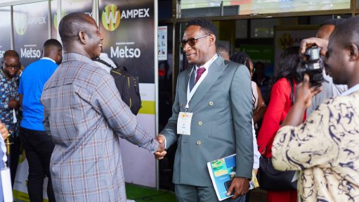 Two Gentlemen in suits shaking hands at the 2025 WAMPEX