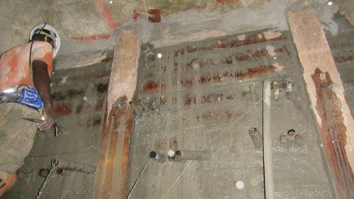 Image of a miner applying a water-sealing solution underground