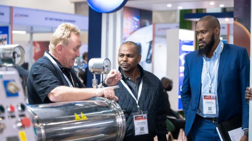 An image of a past Coatings For Africa exhibitor explaining their products to attendees 