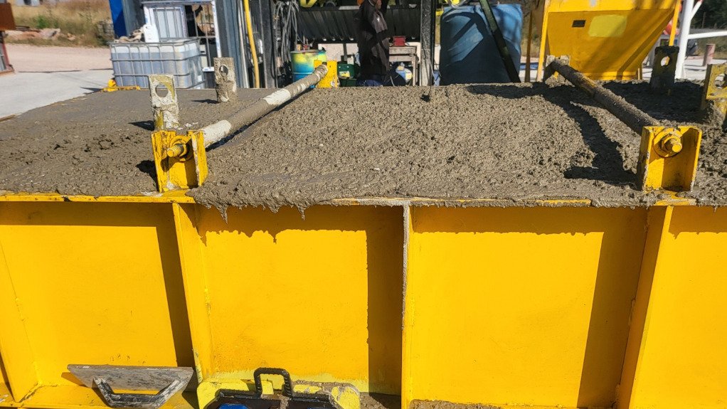 A vibrating machine which removes air pockets from precast concrete pipes 