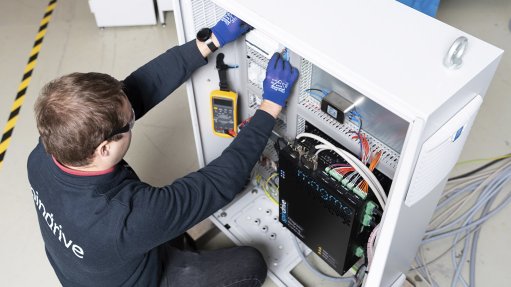 Image of a technician and a Magma X800 AMB controller being tested
