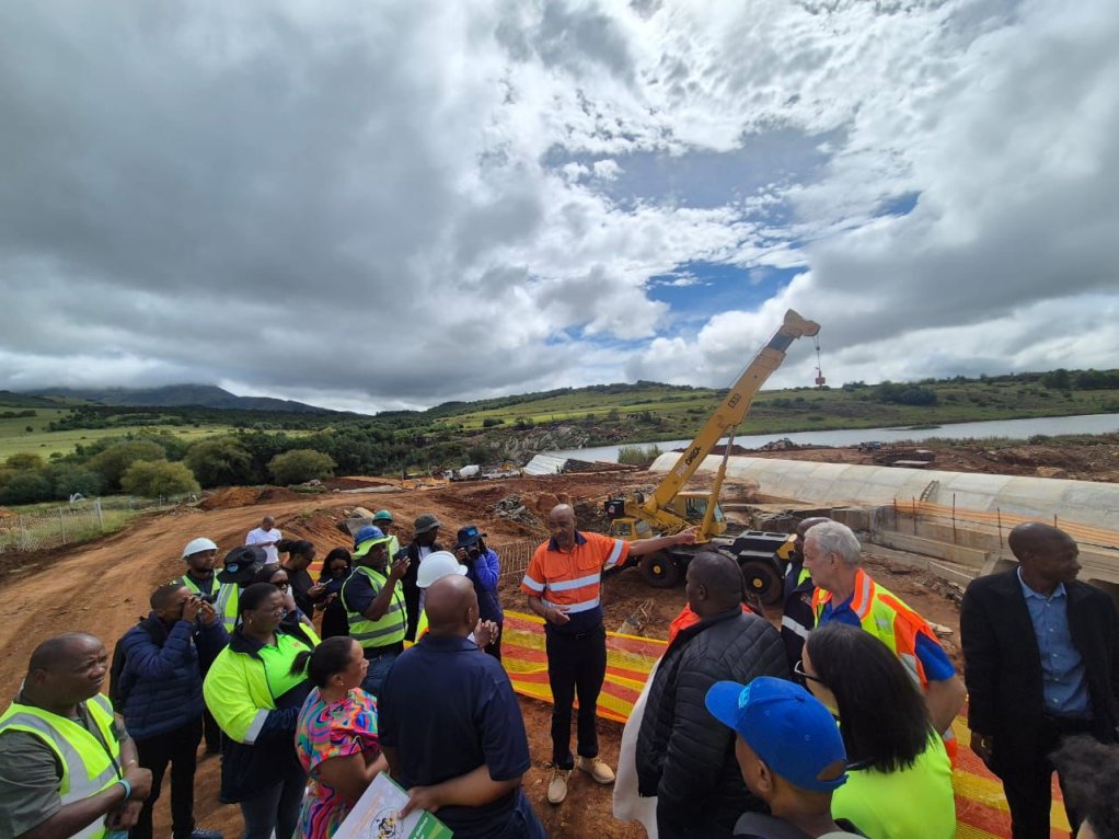 An image of a project manager taking community member through a public infrastructure project