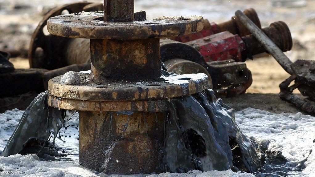 Crude oil pouring from drilling rig well