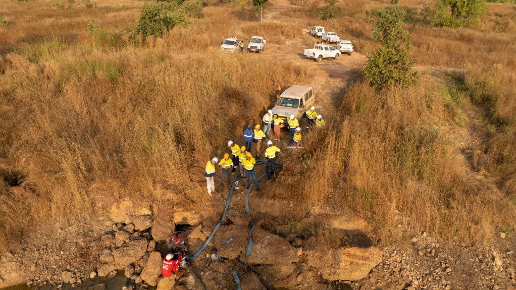 Prospectors and environmental analysts looking at an area of ground in Senegal