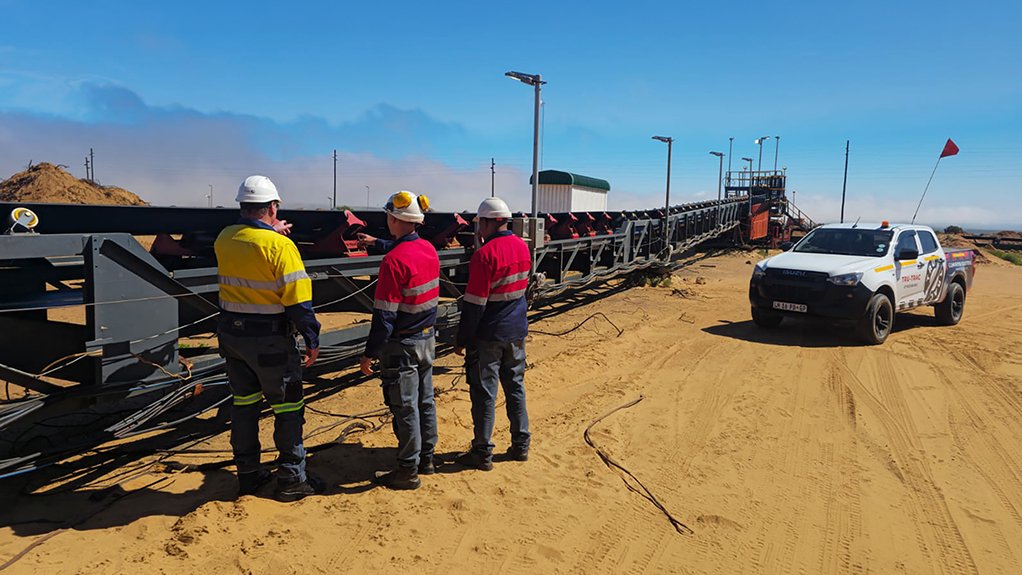 Image of a conveyor on a site and a group of people