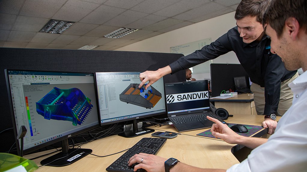 Image of two people looking at images on a computer monitor