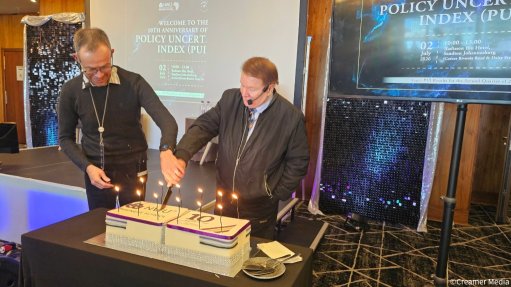 An image of NWU School of Economics Professor Waldo Krugell and NWU Business School Professor Raymond Parsons commemorate the tenth anniversary of the university's Policy Uncertainty Index 