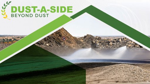 Image of a truck spraying water onto a dirt road