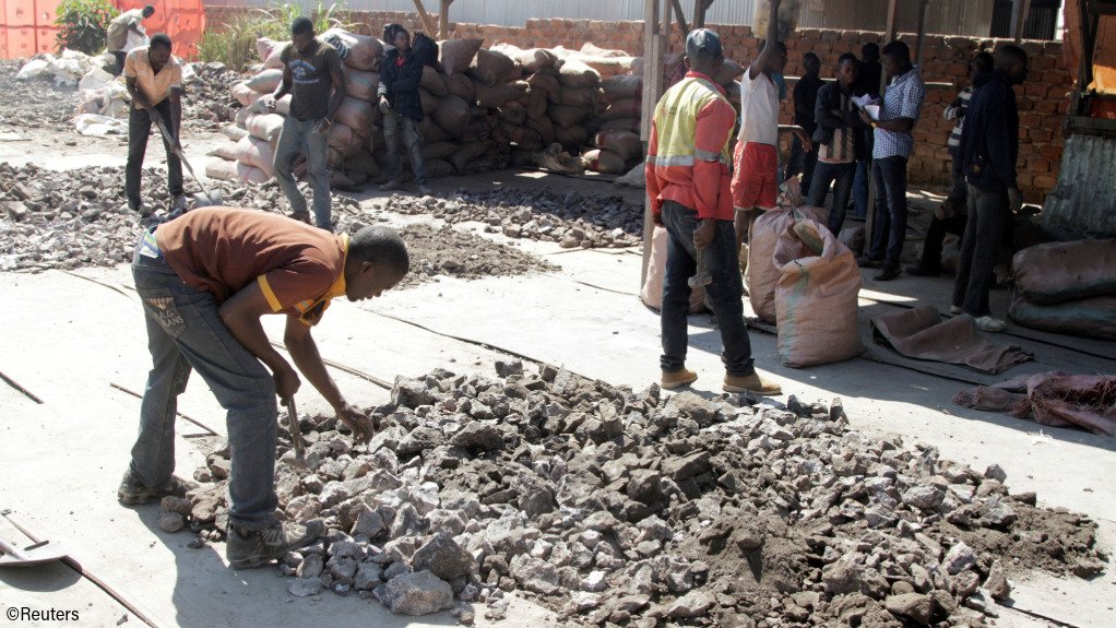 Artisanal miners work at a former industrial copper/cobalt mine, outside of Kolwezi
