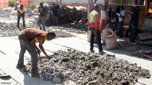 Artisanal miners work at a former industrial copper/cobalt mine, outside of Kolwezi