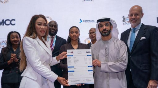 BSE chairperson Neo Mooki and DMCC chairperson and CEO Ahmed Bin Sulayem hold a signed document marking the partnership
