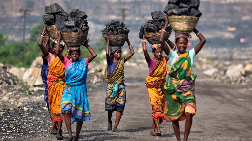 Women carrying baskets with coal