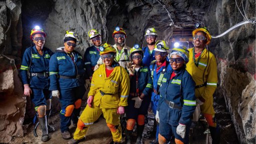 A group of women in an underground mine all in PPE representing gender equity