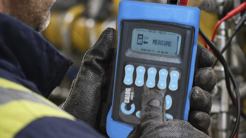 Image of a gloved hand using a calibration machine