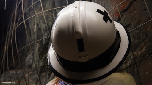 Mineworker wearing a hard hat in an underground mine