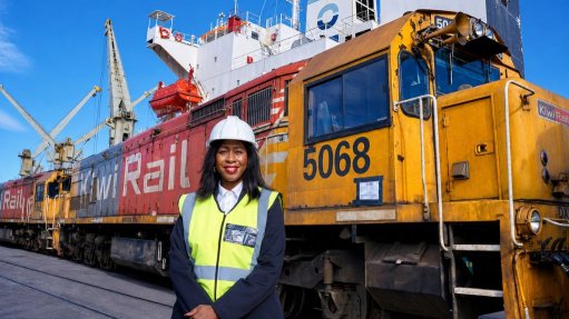 Image of Nnoni in front of a large locomotive