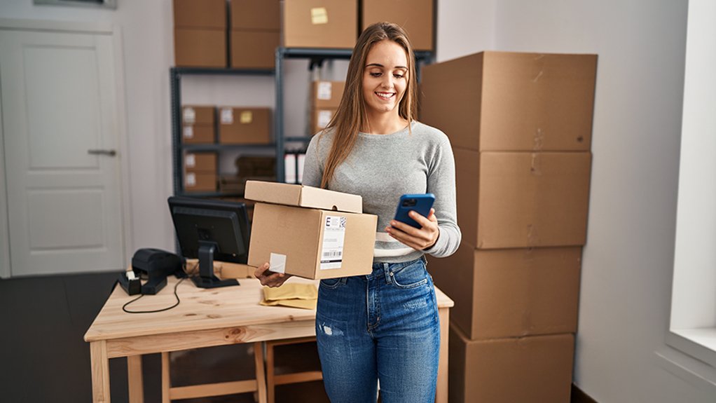 Image of a woman holding a package and a smart phone