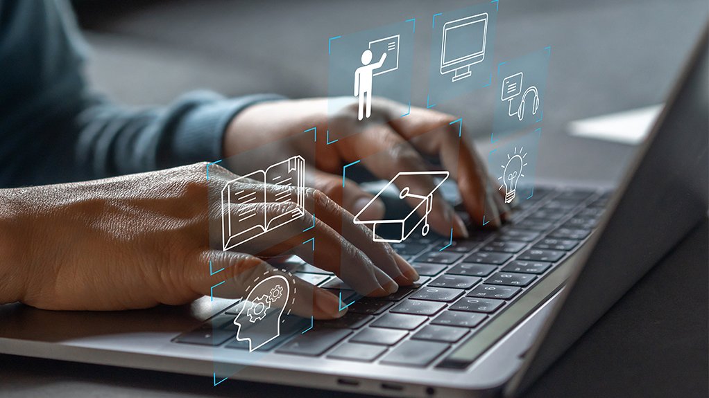 Hands typing on a laptop