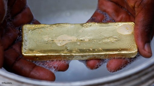 A miner holding a gold bar