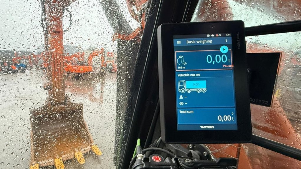 A The Tamtro Excavator Scale on the dash of an excavator with the bucket in the background