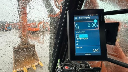 A The Tamtro Excavator Scale on the dash of an excavator with the bucket in the background