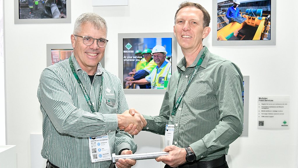 New Multotec chairperson Thomas Holtz handing CEO baton to Johan Robbertse at Electra Mining Africa.