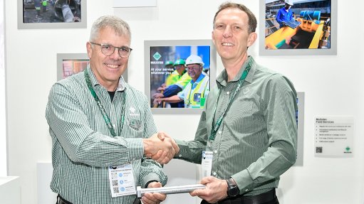 New Multotec chairperson Thomas Holtz handing CEO baton to Johan Robbertse at Electra Mining Africa.