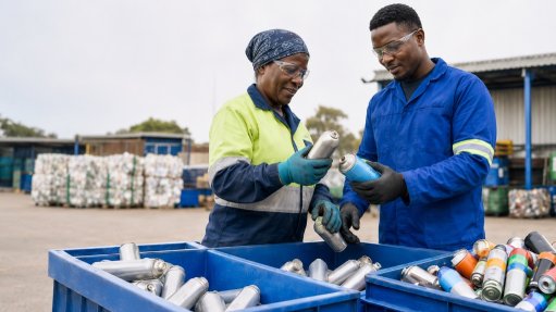 An image of people sorting through aerosol cans for potential reprocessing