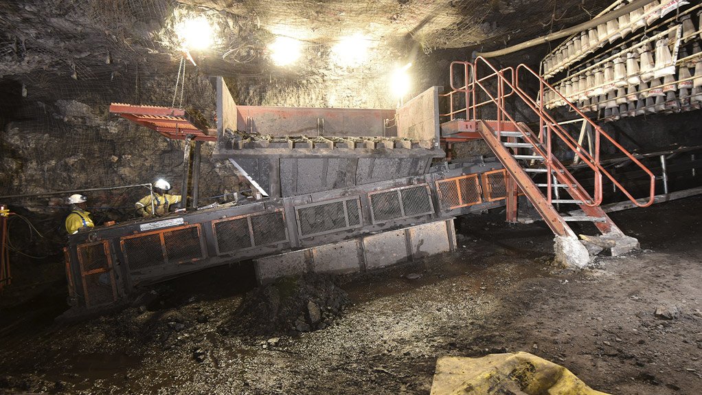 An underground tipping point with a temporary conveyor structure installed to support decline mining. The stone dust barrier on the right provides a critical safety measure to mitigate the risk of underground coal dust explosions