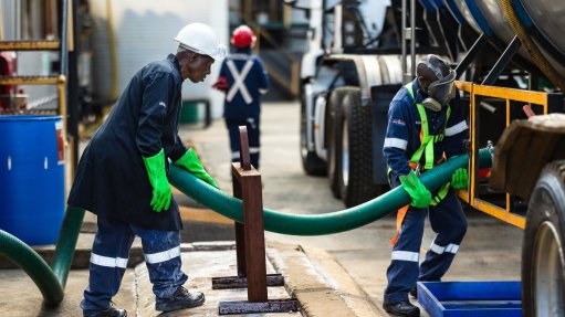 Workers connecting water pipes 