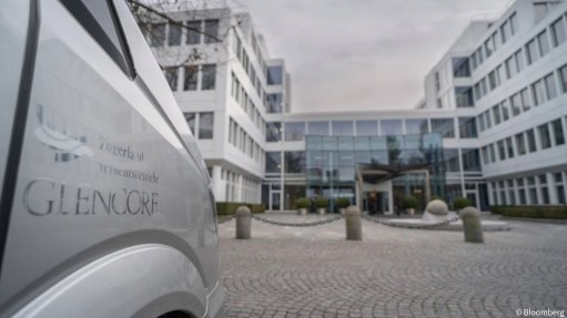 A Glencore-branded vehicle in front of an office building