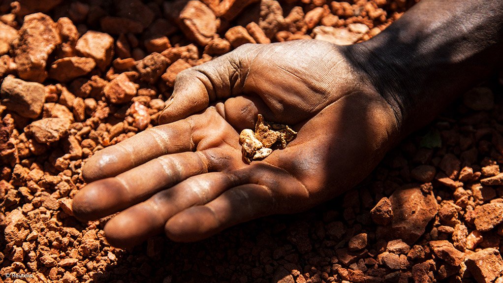 Gold nuggets in a person's hand