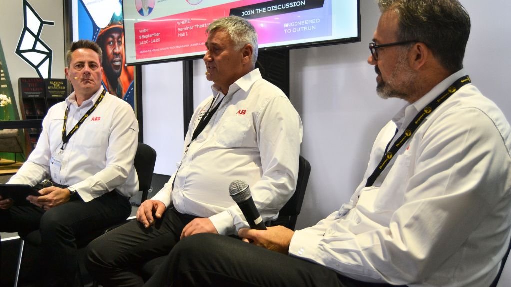 the three men sitting in the panel discussion