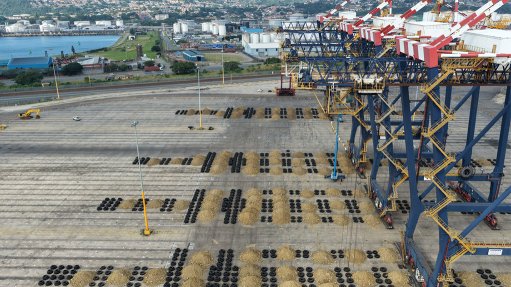 Rows of overburden and discarded straddle carrier tyres formed the impact mattresses, laid out across the quay along each crane's planned landing line.