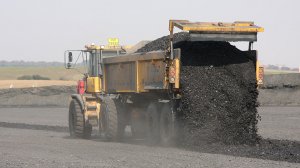 Discard hauler ejecting coal discard material.