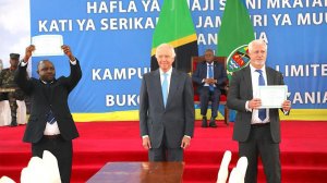 President John Magufuli of Tanzania, seated, looks on as Tanzania's Chief Treasurer Athumani Mbutukwa receives share certificates from Kabanga Nickel vice chairperson Chris von Christierson (centre) and Kabanga Nickel CEO Chris Showalter (right).