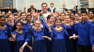 Image of Cape Town Mayor Geordin Hill-Lewis with the Tygerberg Children's Choir at the Council Meeting 