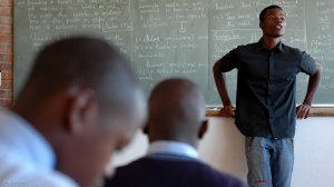 Image of a teacher and learners in a classroom