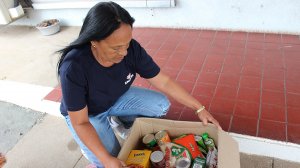Image of Tina Griffiths, Engen Stakeholder Synergies Specialist helps pack food hampers for South Durban residents