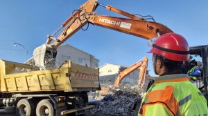 Rubble being removed at the site of a building collapse in George