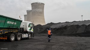 A truck delivering coal to a power station