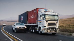 A truck transporting containers 