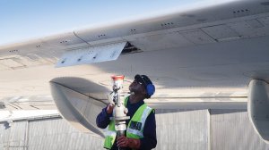 Airport employee preparing to refuel an aircraft