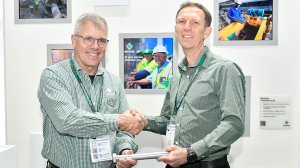 New Multotec chairperson Thomas Holtz handing CEO baton to Johan Robbertse at Electra Mining Africa.